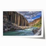 Vibrant landscape print showcasing majestic canyons in rich earth tones, elegantly rolled for easy display; perfect for enhancing home decor.