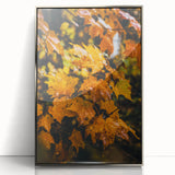 Mid-century modernist art depicting autumn trees in muted orange and brown tones, silver-framed acrylic print.