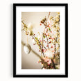 Abstract art print depicting vibrant spring colors on a textured canvas, framed in black, ideal for living room decor.