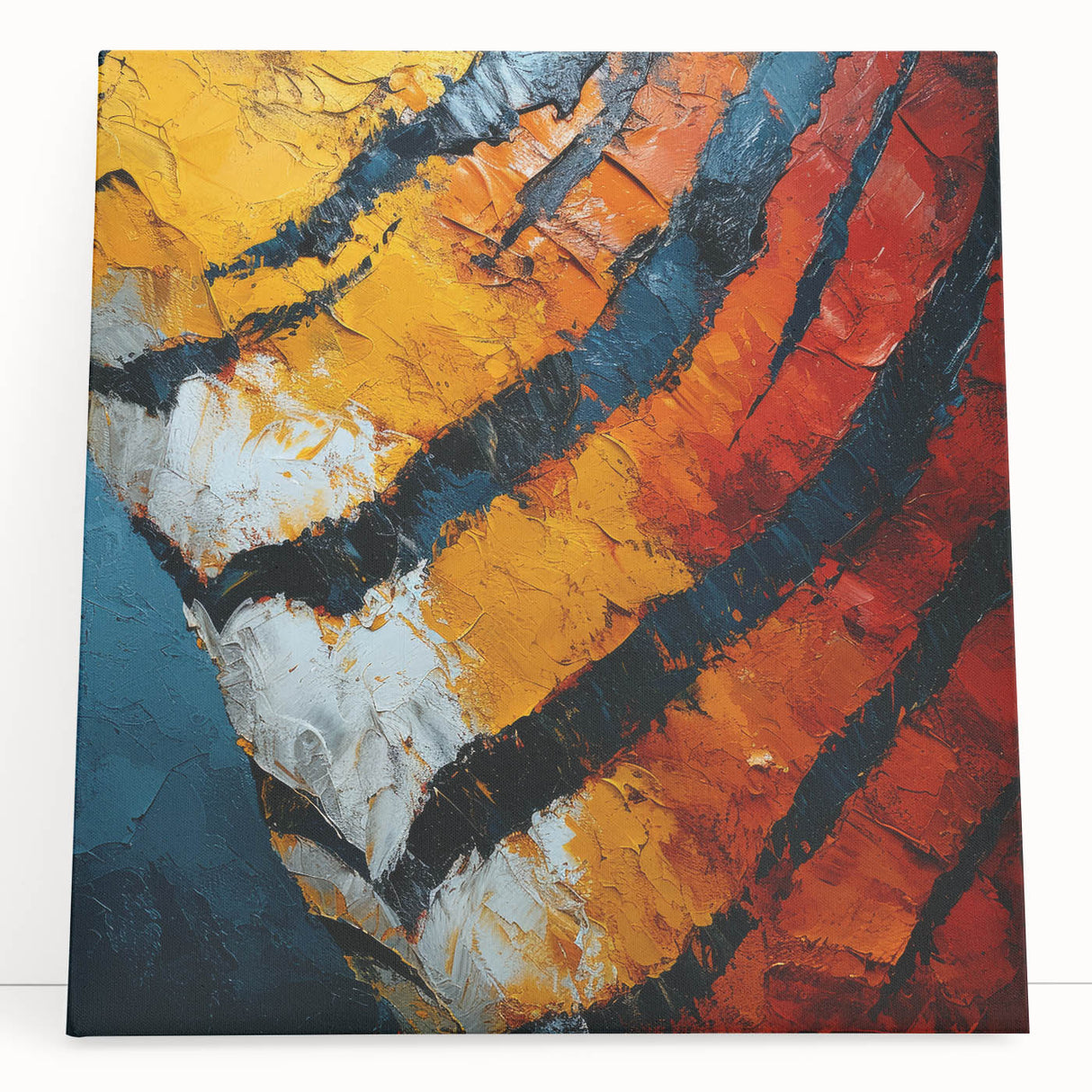 Abstract canvas art showcasing vibrant strokes in shades of blue, orange, and yellow, leaning against a neutral wall, perfect for modern home decor.