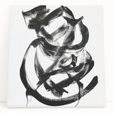 Abstract canvas artwork featuring vibrant strokes in shades of blue, orange, and yellow, showcasing a modern design perfect for contemporary home decor, leaning against a neutral wall.