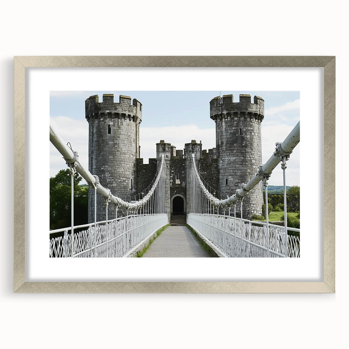 Elegant silver-framed landscape artwork depicting a majestic castle surrounded by lush greenery, highlighted by a white mat, perfect for enhancing home decor.