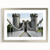 Elegant silver-framed landscape artwork depicting a majestic castle surrounded by lush greenery, highlighted by a white mat, perfect for enhancing home decor.