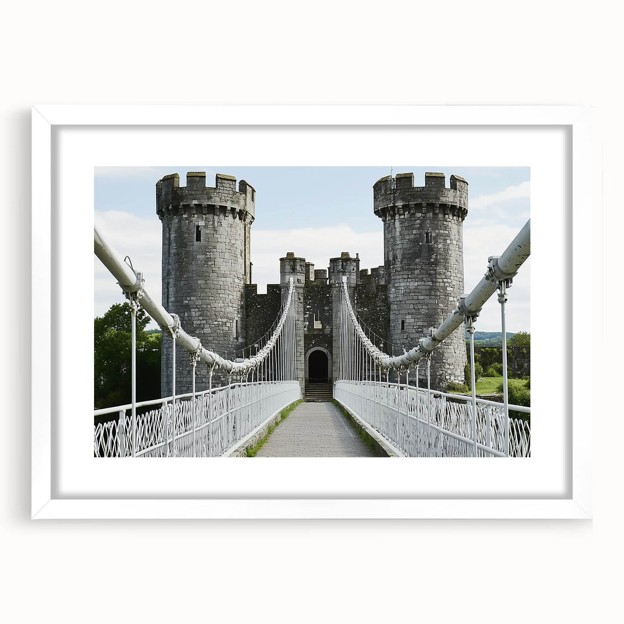 Elegant white-framed landscape print showcasing a majestic castle surrounded by lush greenery, ideal for home decor or office aesthetics.