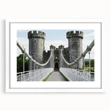Elegant white-framed landscape print showcasing a majestic castle surrounded by lush greenery, ideal for home decor or office aesthetics.