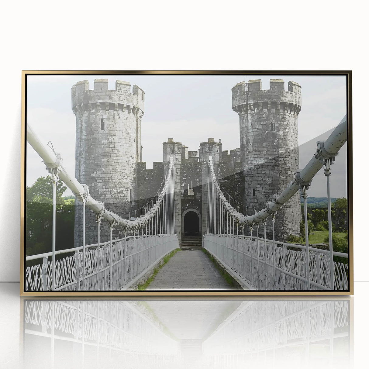 Framed acrylic artwork showcasing a picturesque landscape with a majestic castle, set against a vibrant sunset, accented with elegant gold trim.