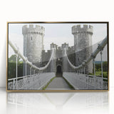 Framed acrylic artwork showcasing a picturesque landscape with a majestic castle, set against a vibrant sunset, accented with elegant gold trim.