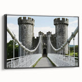 Framed canvas art featuring a picturesque landscape with a majestic castle, set against a serene sky. The black frame complements the vibrant colors, ideal for home decor.
