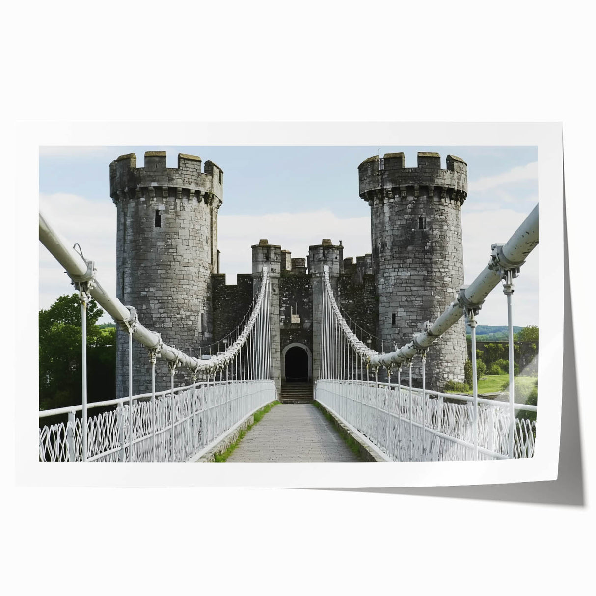 Rolled art print showcasing a picturesque landscape with a majestic castle amidst lush greenery, elegantly packaged in a protective cardboard tube for safe delivery.