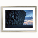 Framed landscape artwork showcasing a dramatic cliff scene with vibrant colors, accented by a silver matting. Perfect for home decor or gallery display.