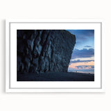 Framed landscape art print showcasing dramatic cliffs under a blue sky, featuring a white mat and sleek black frame, perfect for modern home decor.
