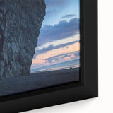 Close-up of a framed canvas artwork depicting a stunning landscape with dramatic cliffs and vibrant colors, perfect for adding a touch of nature to home decor.