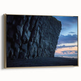 Framed canvas artwork depicting a stunning landscape with dramatic cliffs and vibrant colors, highlighted by a luxurious gold frame, perfect for home decor.