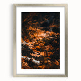Textured abstract art print depicting autumnal hues on a silver-framed canvas, suitable for bedroom decor.