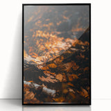 Large abstract wall art depicting fall season in warm orange and brown tones on a framed acrylic.