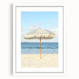 Abstract art print featuring swirling blue and white patterns, framed in white, suitable for dining room decor.