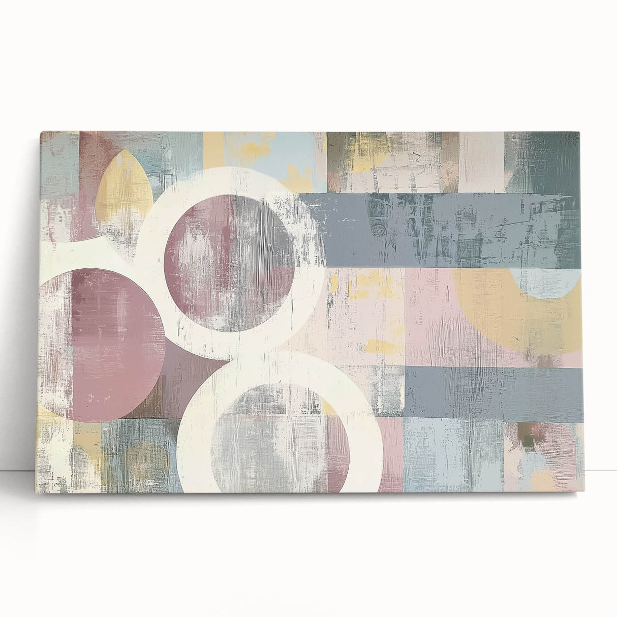 Abstract strokes on a stretched canvas artwork, showcasing vibrant colors like blue, yellow, and red, leaning against a neutral wall, perfect for modern decor.
