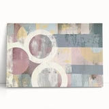 Abstract strokes on a stretched canvas artwork, showcasing vibrant colors like blue, yellow, and red, leaning against a neutral wall, perfect for modern decor.