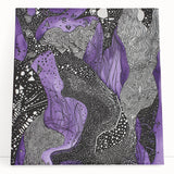 Abstract canvas art showcasing vibrant strokes in shades of blue, pink, and gold, elegantly leaning against a neutral wall, adding a modern touch to interior decor.