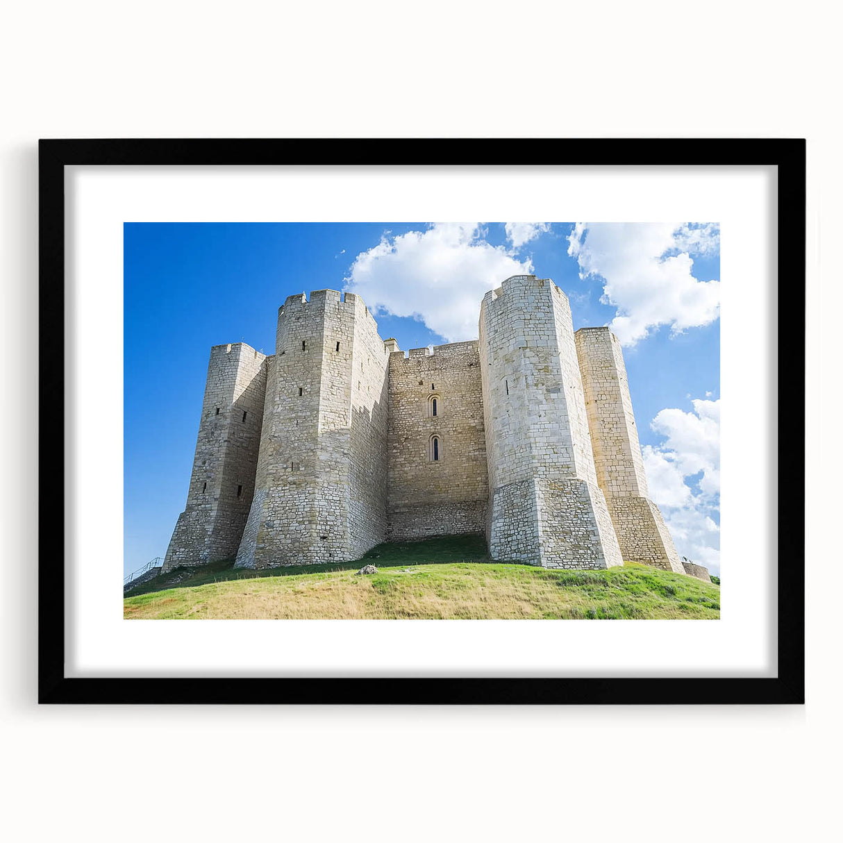 Framed landscape artwork showcasing a picturesque castle scene, elegantly matted in black, ideal for enhancing home decor aesthetics and artistic ambiance.