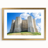 Elegant gold-framed landscape artwork featuring a picturesque castle scene, accented with a white mat for a sophisticated touch, perfect for home decor.