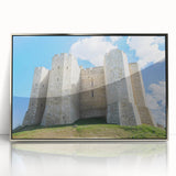 Framed acrylic artwork showcasing a stunning landscape of a castle set against a vivid blue sky, featuring intricate details and a silver frame, ideal for home decor.