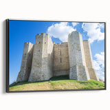 Framed canvas artwork showcasing a picturesque landscape with a majestic castle set against a vibrant sunset, elegantly presented with a sleek black frame. Ideal for enhancing home decor and adding a touch of elegance to living spaces.