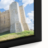 Close-up of a framed canvas print depicting a majestic castle landscape, showcasing intricate details and vibrant colors, perfect for home decor enthusiasts.