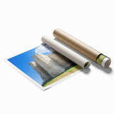 Rolled canvas print showcasing a vibrant landscape with a majestic castle surrounded by lush greenery, elegantly packaged in a protective cardboard tube for safe delivery.