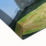 Close-up of a stretched canvas depicting a serene landscape with a majestic castle, showcasing vibrant colors and intricate details, perfect for home decor.