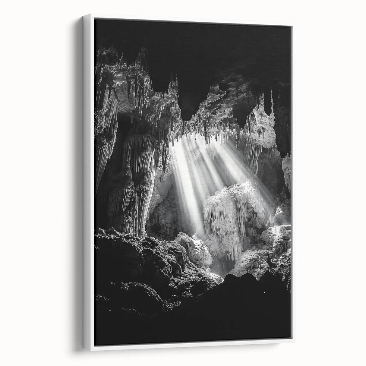 Framed canvas artwork depicting a serene landscape scene with caves, showcasing earthy tones and textures, displayed with a white frame for a modern touch. Ideal for home decor and nature enthusiasts.