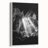 Framed canvas artwork depicting a serene landscape scene with caves, showcasing earthy tones and textures, displayed with a white frame for a modern touch. Ideal for home decor and nature enthusiasts.