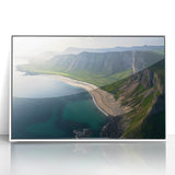 Framed acrylic artwork depicting a stunning landscape of rugged cliffs under a vibrant sunset, featuring rich colors of orange and blue, ideal for modern home decor.