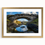 Gold-framed landscape bridge artwork with a mat, showcasing intricate details and vibrant colors, perfect for enhancing home decor and gallery displays.