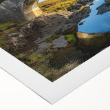 Rolled canvas artwork depicting a serene landscape bridge scene, showcasing vibrant colors and intricate details, securely packaged in a protective cardboard tube for shipping.