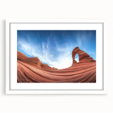 Framed landscape artwork depicting canyons in rich earth tones, featuring a white mat and sleek black frame, ideal for enhancing home decor and aesthetic appeal.