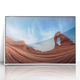 Framed acrylic artwork showcasing a vibrant landscape of canyons, featuring rich earth tones and dramatic rock formations, mounted in a sleek white frame for modern decor.