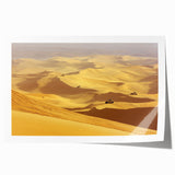 Desert landscape rolled canvas print showcasing vibrant hues of orange and yellow, highlighting sand dunes under a clear blue sky, ideal for home decor.