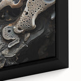Close-up of textured black wall art with colorful abstract elements on a framed canvas.