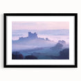 Elegant black-framed landscape artwork depicting a serene castle scene, accented by a white mat, ideal for home decor and enhancing interior aesthetics.