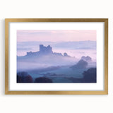 Elegant gold-framed landscape artwork depicting a majestic castle surrounded by lush greenery, enhanced with a decorative mat, perfect for home decor.