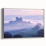 Framed canvas artwork depicting a scenic landscape with a castle, showcasing intricate details and rich colors, displayed against a silver frame, perfect for home decor.