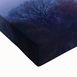 Close-up view of a stretched canvas depicting a serene landscape featuring a majestic castle surrounded by lush greenery, perfect for home decor.