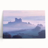 Stretched canvas artwork depicting a serene landscape with a majestic castle surrounded by lush greenery and a clear blue sky, ideal for home decor.