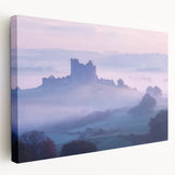 Stretched canvas artwork depicting a serene landscape with a majestic castle surrounded by lush greenery and vibrant blue skies, perfect for home decor.