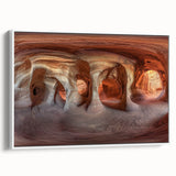 Framed canvas artwork depicting a serene landscape with caves, featuring earthy tones and intricate details, showcased from a white side view for a modern aesthetic.