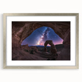 Framed landscape artwork featuring a stunning canyon scene, presented in a sleek silver frame with a white mat, enhancing the vibrant colors of the natural landscape. Ideal for home decor or office settings.