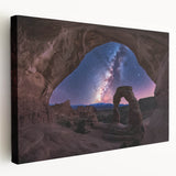 Stretched canvas artwork depicting a vibrant landscape of canyons under a clear blue sky, showcasing rich earth tones and dramatic rock formations, ideal for nature-inspired decor.