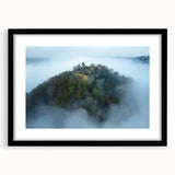 Elegant black-framed landscape artwork showcasing a majestic castle surrounded by lush greenery, designed with a white mat for a refined look. Perfect for home decor.