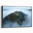Framed canvas artwork depicting an enchanting landscape with a castle, featuring a black frame and side view, ideal for home decor and wall art enthusiasts.